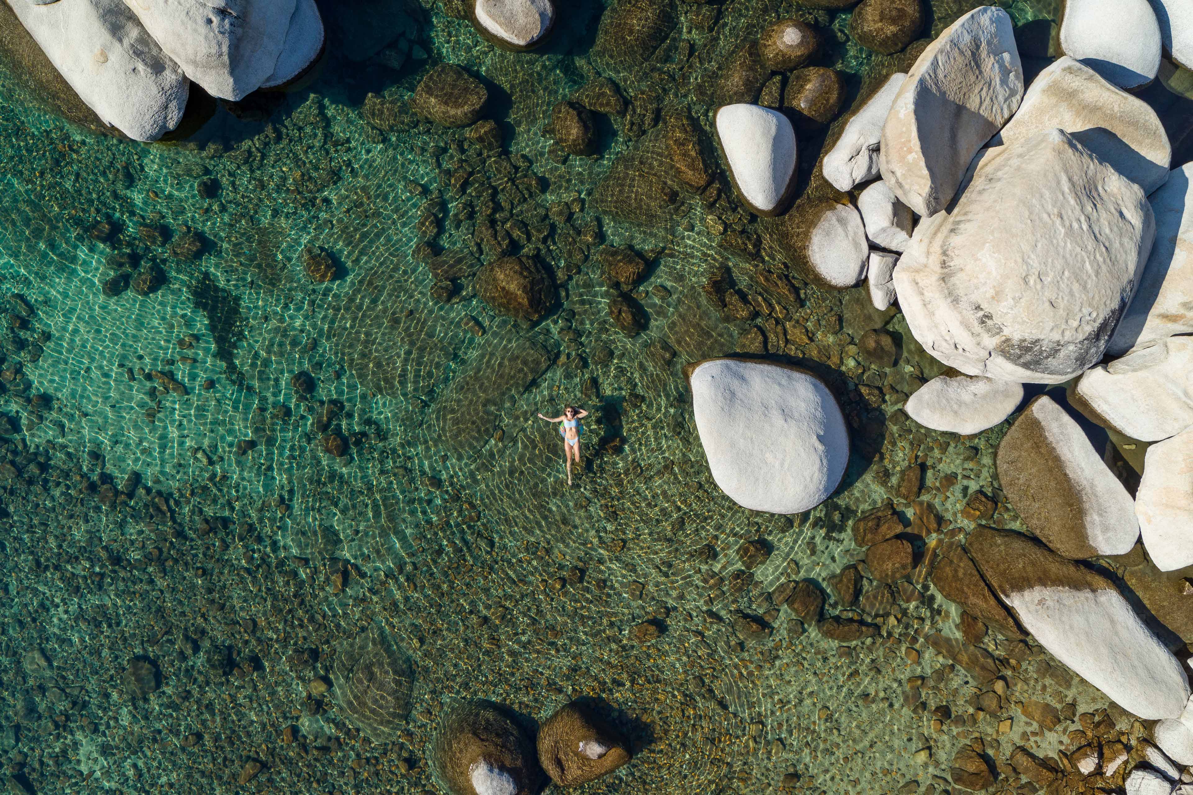 woman floating super relaxed on the tahoe lake